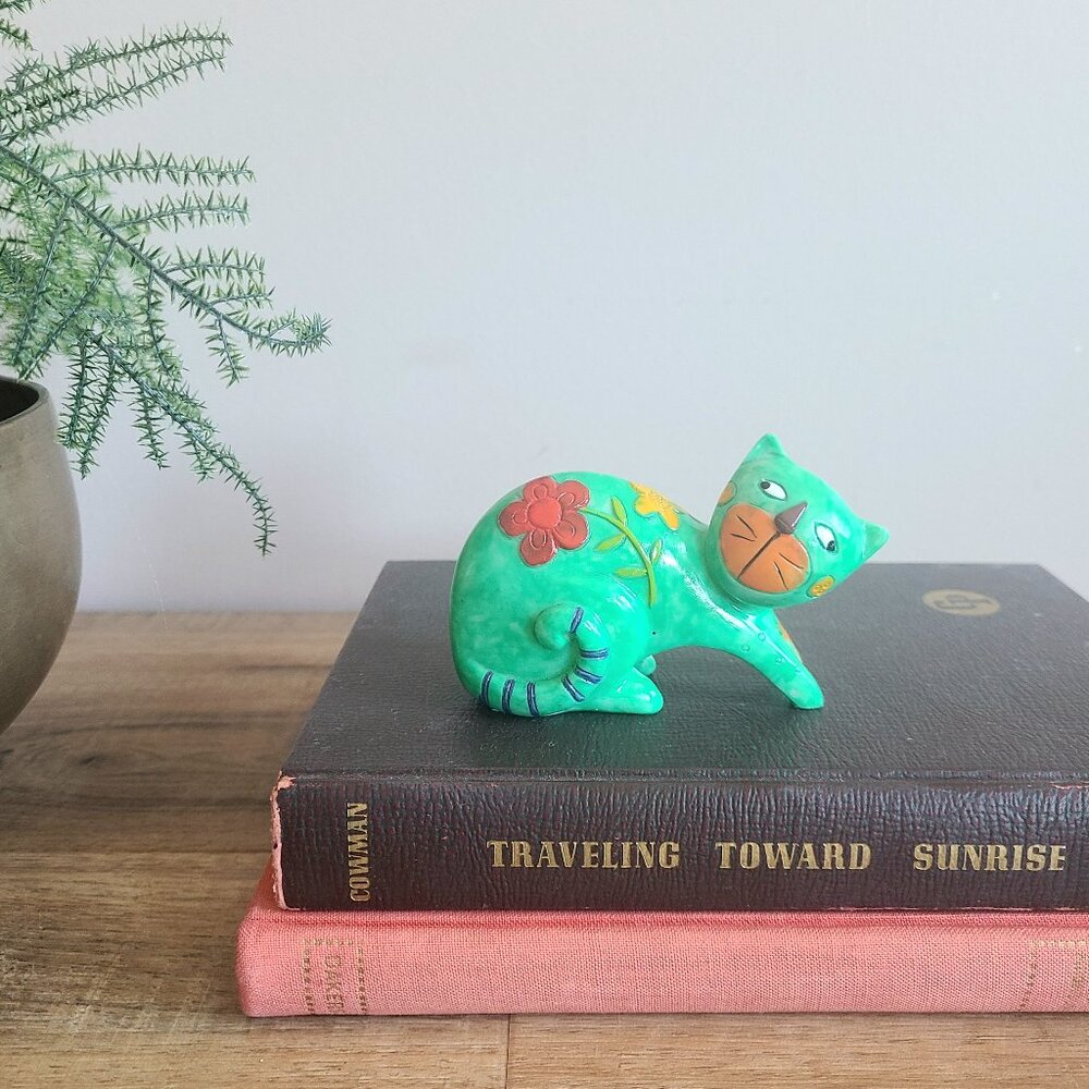 Green cat figurine.